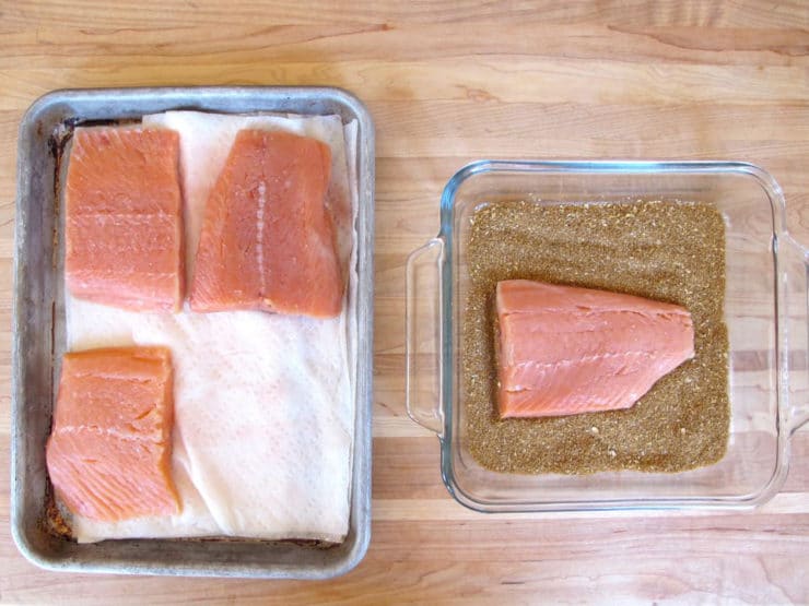 Salmon fillets on a lined baking sheet.