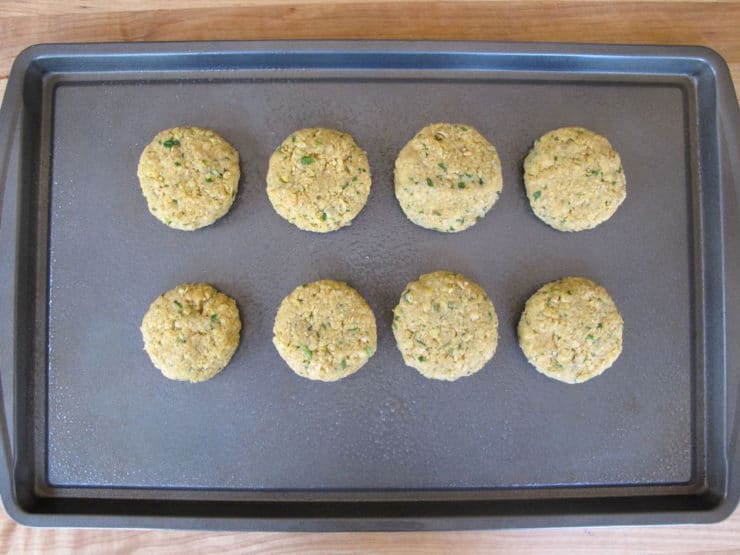 Chickpea patties on a baking sheet.
