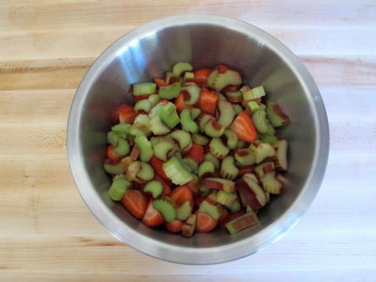 Diced rhubarb with strawberries in a mixing bowl.