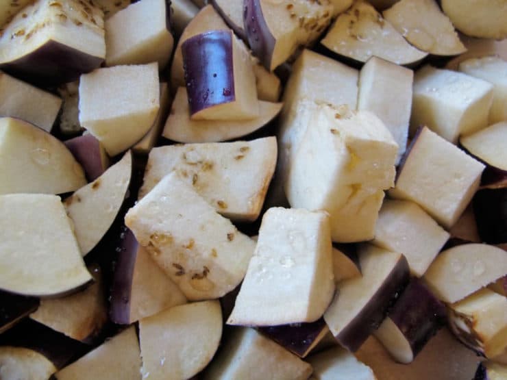Salt drawing water out of cubed eggplant.