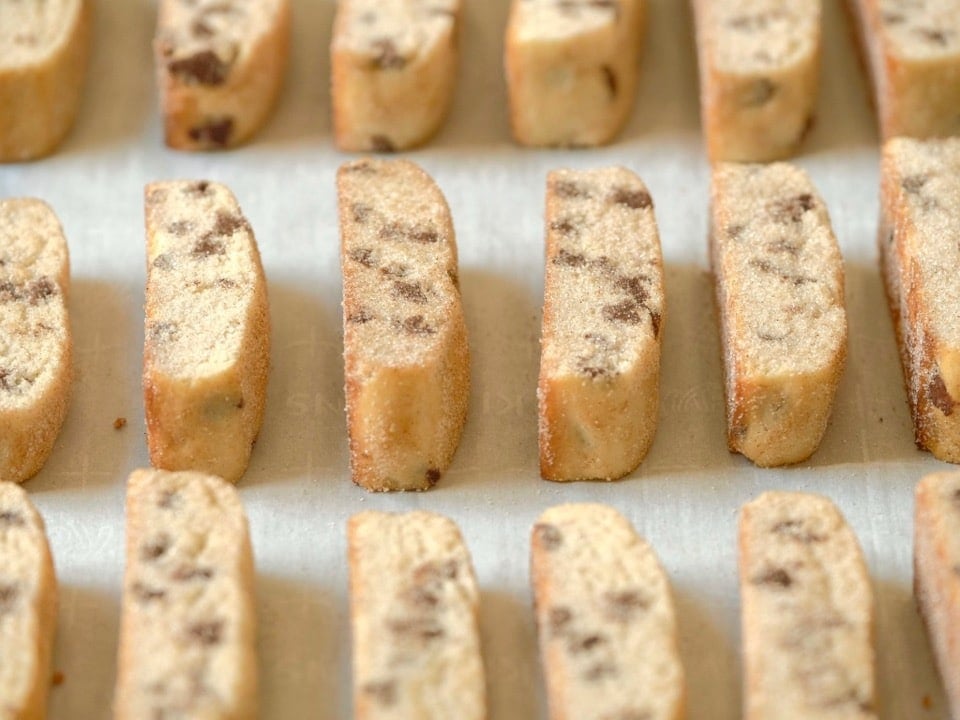 A tray of Mandel Bread cookies topped with chocolate chips.