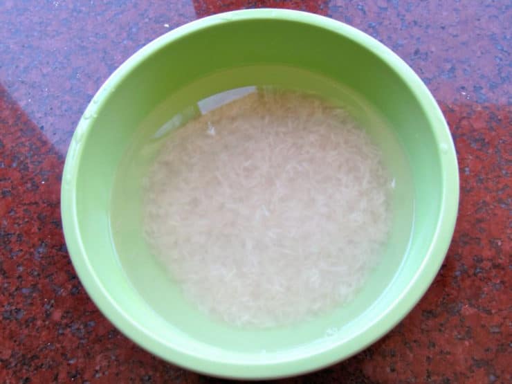 White rice soaking in a bowl of water.
