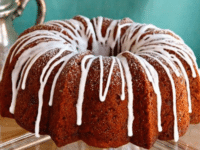Delicious Apple Honey Cake slice served with a cup of tea and a fork on the side