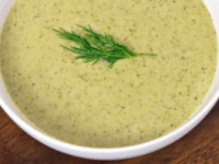 Creamy Broccoli Tahini Soup Pinterest Pin - A bowl of Creamy Broccoli Tahini Soup garnished with a dill sprig.