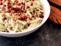 Close-up of Fennel apple salad with cider tahini dressing in a bow topped with pomegranate seeds