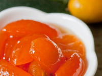 Close-up of a small white bowl full of Honey-Preserved Kumquats