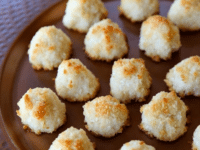 A plateful of Lemony Almond Macaroons on top of a wooden table