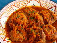 A plate of Polish Chicken Patties served with carrots, parsley, and sauce