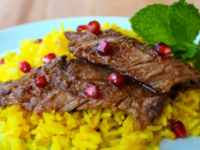 Delicious pomegranate-spiced beef with rice, topped with Pomegranate Molasses Brisket. Pinterest Pin at ToriAvey.com