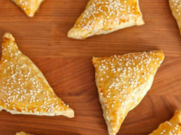 Flaky pastry filled with a savory blend of potatoes and cheese. A delicious and satisfying snack or appetizer. Pinterest pin at ToriAvey