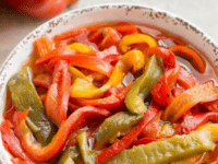 A bowl filled with colorful chopped roasted peppers
